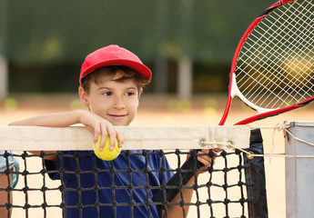 Wall Mural - Cute little boy with tennis racket on court