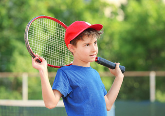 Wall Mural - Cute little boy with tennis racket on court