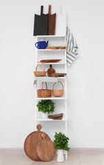 Canvas Print - Storage stand with different wooden boards in kitchen