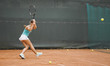 © danilnevsky/Stocksy - Tennis player in motion hits the ball
