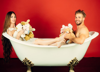 Wall Mural - Boyfriend and girlfriend relax on red background.