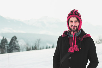 young man looking confident in winterscape