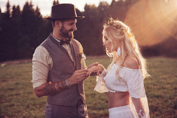 bride and groom outdoors. wedding ceremony. wedding arch.