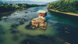 © Koki Jovanovic/Stocksy - cottage on the rocks in the river Drina