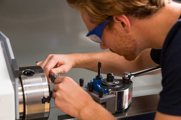 Fitter working at Turning machine in metal workshop