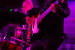 © Angelov - Closeup photo of bass guitar player hands, soft selective focus, bright live music theme