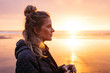 © jessemorrow/Stocksy - side profile portrait of young woman at sunset on beach