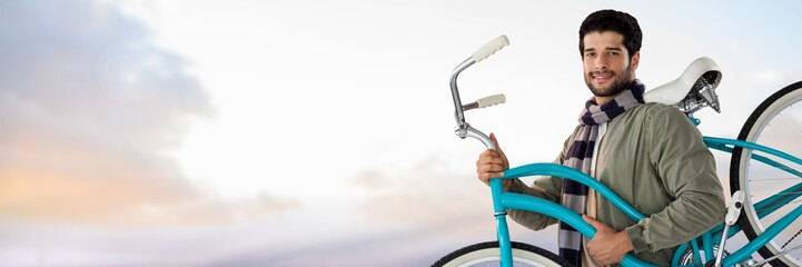 Wall Mural - man holding bicycle with calm sky