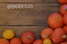 Pumpkins On Wooden Planks With Pieces Of Wood Lettering The Word Of The Month OCTOBER