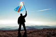 Successful silhouette man winner waving Democratic Republic of Congo flag on top of the mountain peak