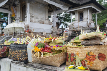 Traditional hindu balinese offerings as flowers, money and food in a basket in Pura Penataran Agung Lempuyang, Bali, Indonesia