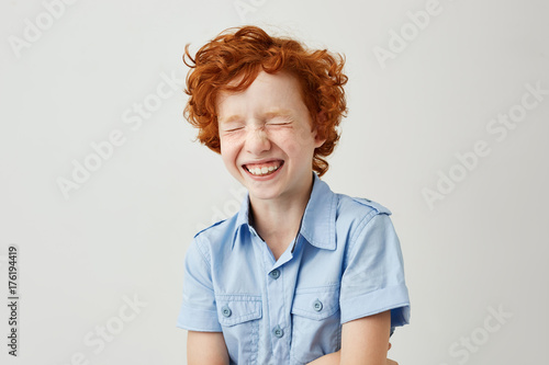 Close Up Portrait Of Cheerful Little Kid With Curly Ginger Hair
