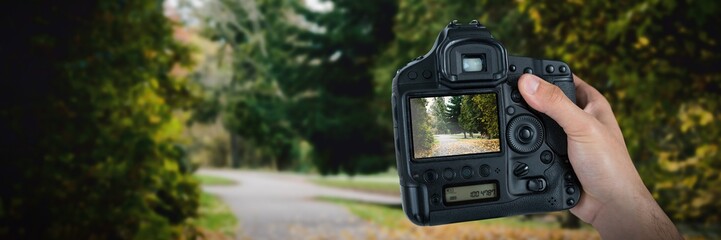 Sticker - Composite image of cropped hand of photographer holding camera 