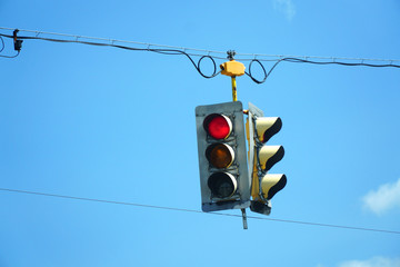 Wall Mural - red traffic light hanging against sky