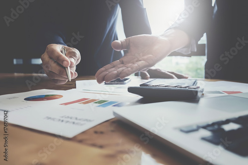 Cuadros en Lienzo Businessman pointing graph chart with partner for analyze plans in this month