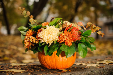 Pumpkin with a beautiful autumn flower composition