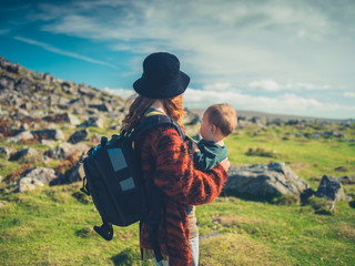 Mother with baby trekking in wilderness