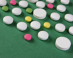 Wall Mural - Pills and tablets on a green background