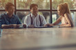 © boonchok - Business team and their customer are negotiating a trade agreement or business plan. (With workspace)