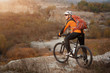 © Aleksey - Mountain biking down the trail. Tourist with backpack travel on bike.