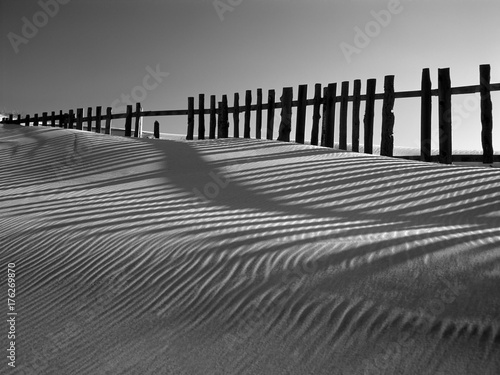 Sand dune against fences