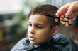 © Aleksandr - Little boy on a haircut in the barber sits on a chair.