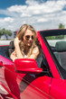 © speed300 - Blonde beautiful woman in sunglasses sitting in red car by the sea. Vacation concept. Happyness. Freedom. Road trip on beautiful sunny summer day