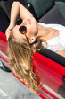 © speed300 - Blonde beautiful woman in sunglasses sitting in red car by the sea. Sea view. Vacation concept. Happyness. Freedom. Road trip on beautiful sunny summer day