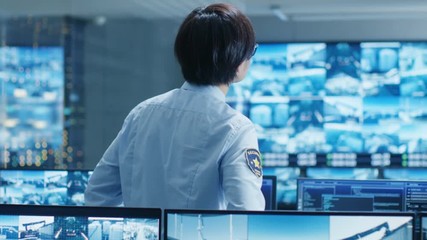 Aufkleber - In the Security Control Room Officer Monitors Multiple Screens for Suspicious Activities. He Guards Internationally Important Logistics Facility. Shot on RED EPIC-W 8K Helium Cinema Camera.