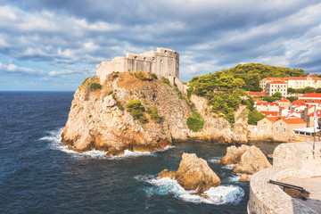 Wall Mural - Dubrovnik medieval fortress Lovrijenac (St. Lawrence) on the rock, beautiful landscape with blue cloudy sky and Adriatic sea, popular view from the ancient city wall, Croatia