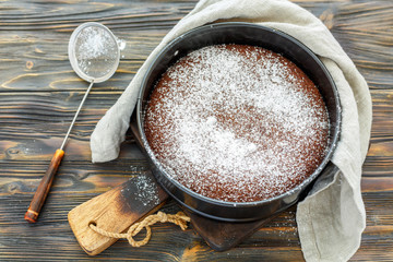 Wall Mural - Chocolate cake sprinkled with powdered sugar.