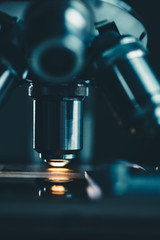 Wall Mural - close-up shot of microscope with metal lens at laboratory.