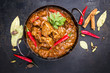 Traditional Indian curry lamb masala as close-up in a Korai