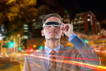 Wall Mural - Composite image of businessman using virtual reality glasses