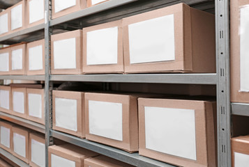 Canvas Print - Cardboard boxes with documents on shelving unit in archive