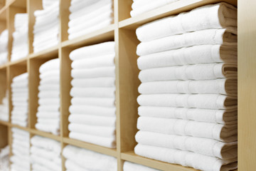 Leinwandbilder - Fresh White Hotel Towels Folded and Stacked on a Shelf