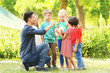© Africa Studio - Group of children with teacher in park on sunny day