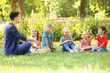© Africa Studio - Group of children with teacher in park on sunny day
