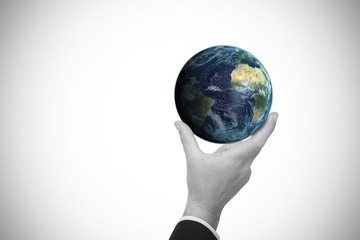 Poster - Composite image of businessman pointing little earth with his