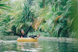 © Odua Images - young woman enjoying tubing at lazy river pool