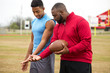 © digitalskillet1 - Coach training a high school athlete.