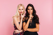 © Drobot Dean - Calm beautiful ladies in party dresses showing silence gesture