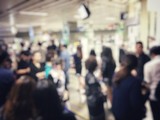 Fototapeta Zachód słońca - blurred image of asian people on the queue line on rush hour waiting for train subway station. Stay in the crowd cause stress in everyday life and jeopardize people health. Transport concept