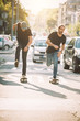 © guruXOX - Two pro skateboard rider ride skate through cars on street