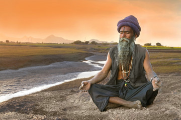 sadhu meditation near river