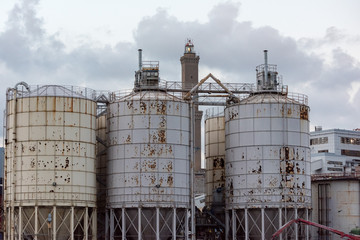 Wall Mural - metallic silos near Lightouse Lanterna Genoa town