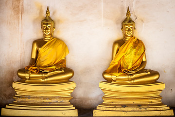 two old gold buddha image Thailand art in the old temple in Ayutthaya Thailand 