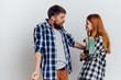 © SHOTPRIME STUDIO - Woman with a man on a white background quarrel over a repair