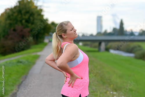 Fotografía Young blonde woman holding her painful back