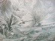 © Matthew Spaulding/Stocksy - Ice and frost formation with feather pattern on car windshield